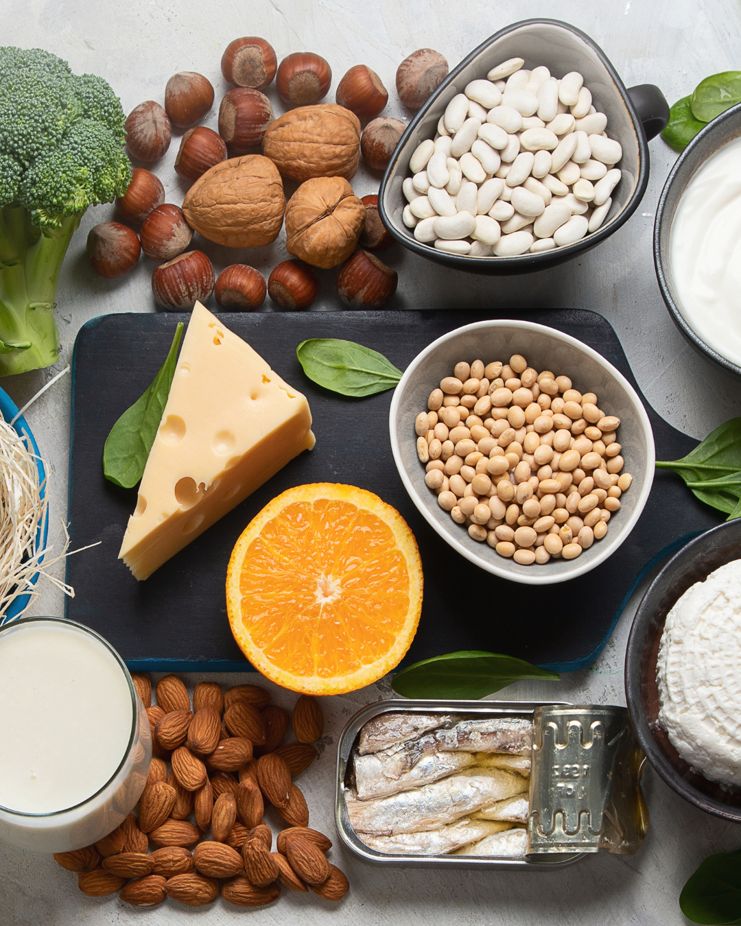 A photo of many foods high in calcium, like nuts, cheese, and milk