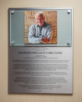 a plaque reading "Golisano Specialty Care Clinic" featuring a picture of namesake Tom Golisano.