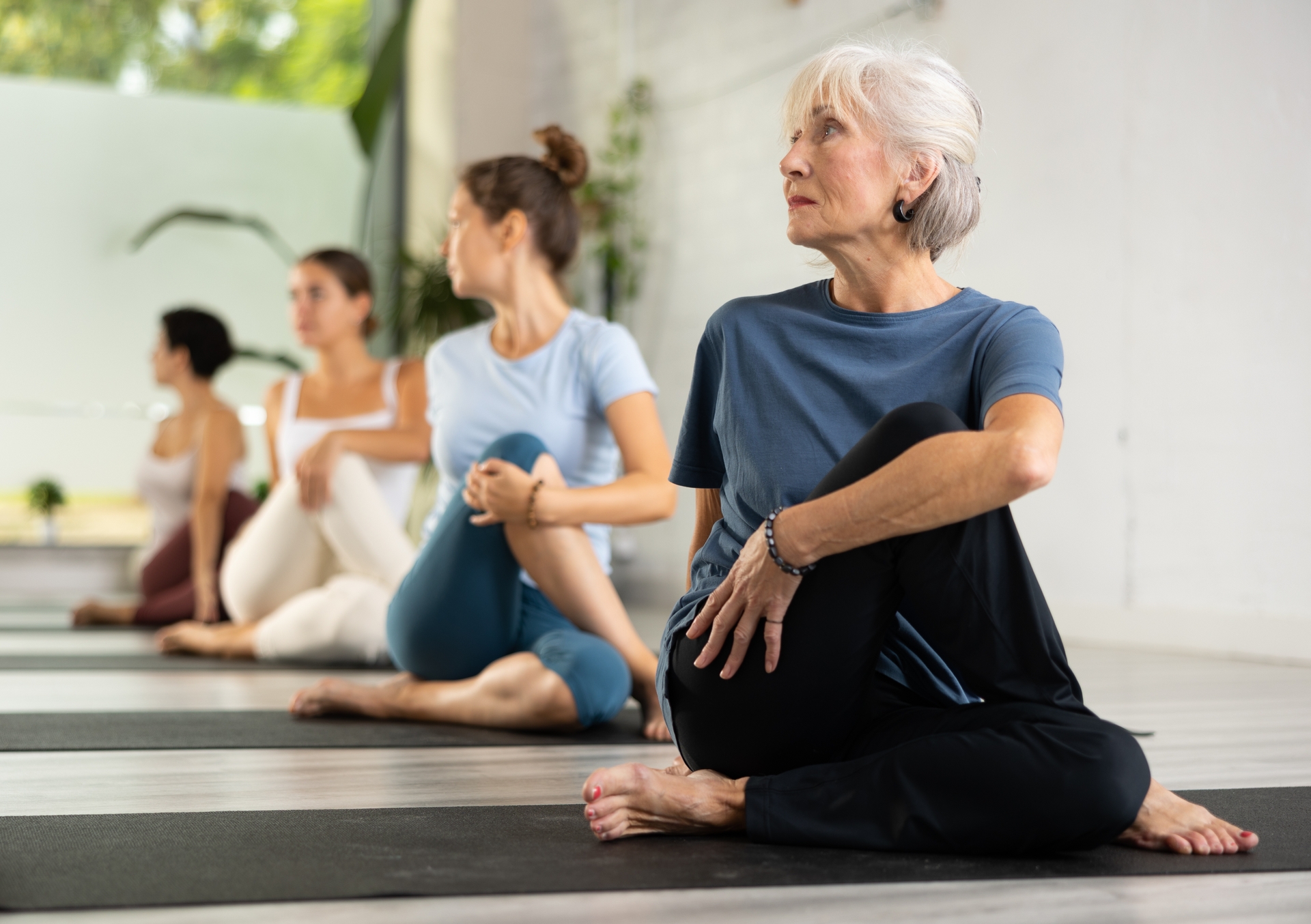 older adults stretching in yoga class