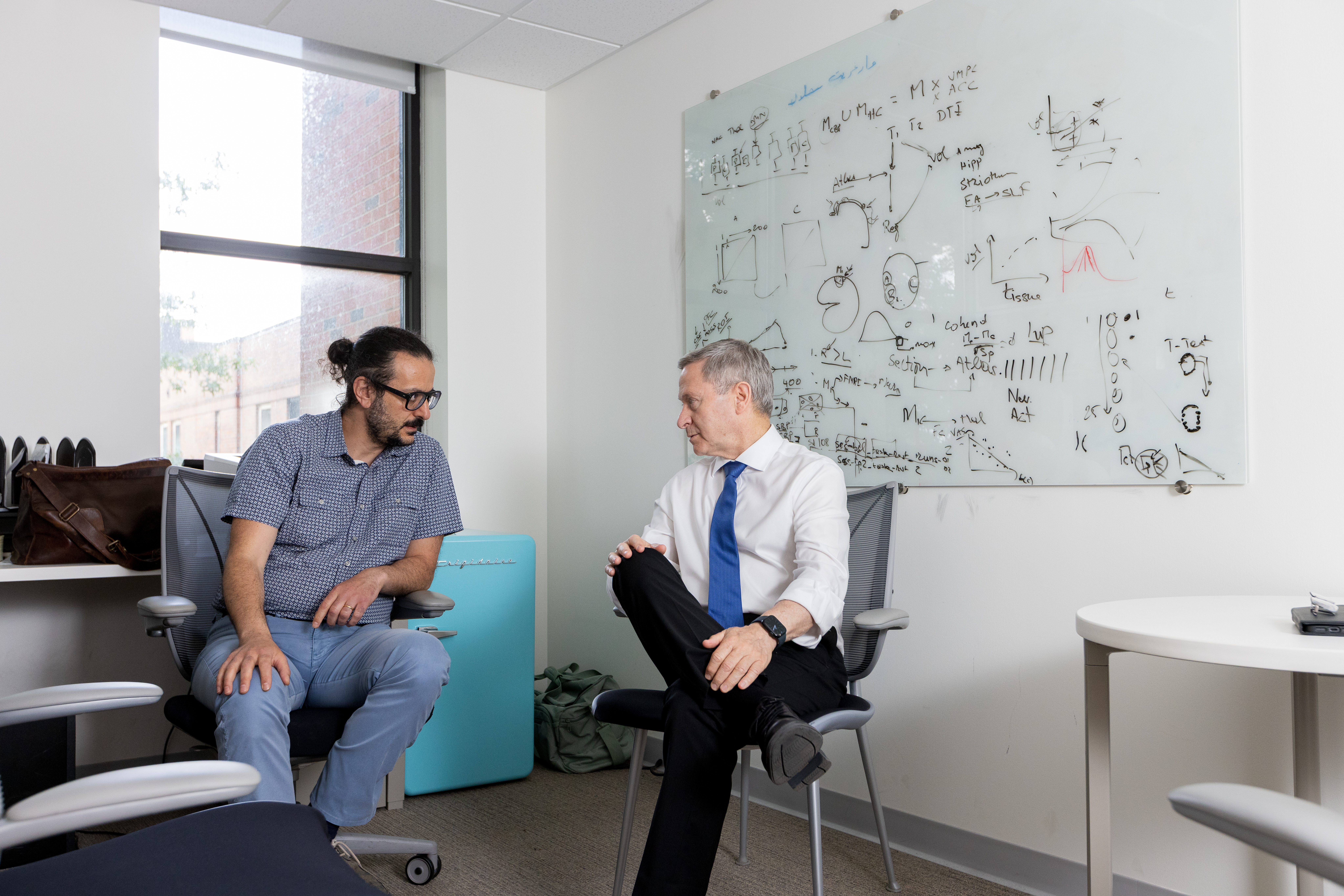 Eliav (right) and Geha meet in his office in the University of Rochester Center for Advanced Brain Imaging & Neurophysiology.