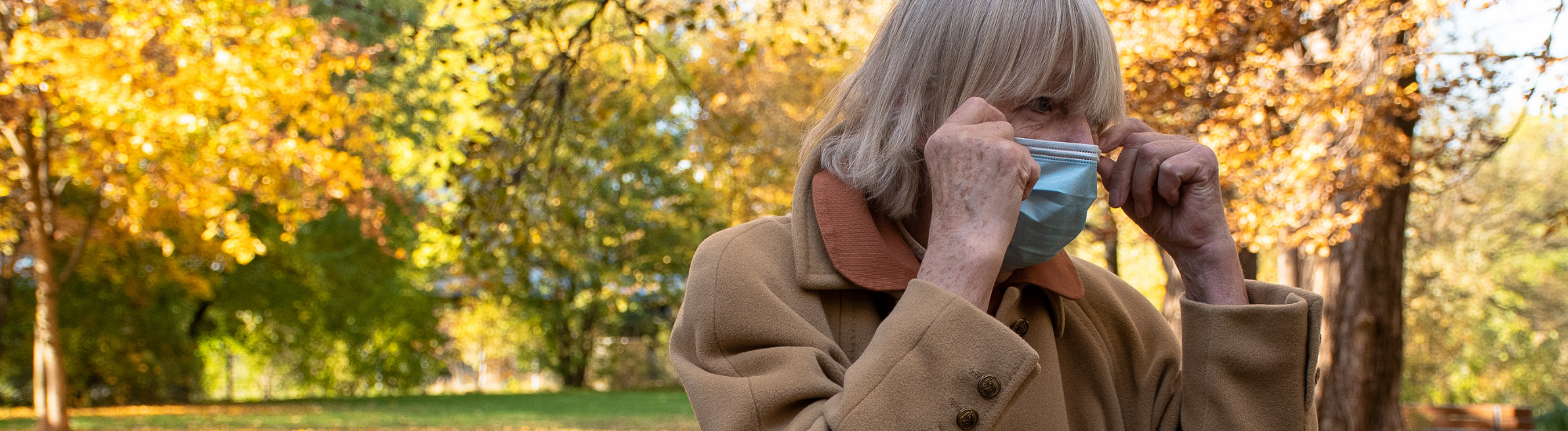 woman wearing mask outside in the fall