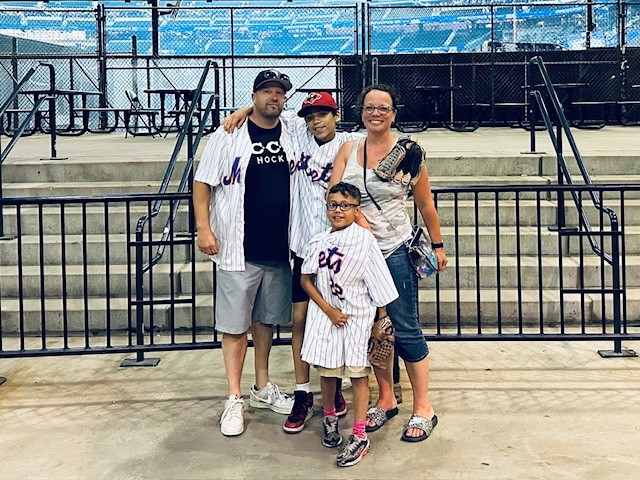 Family poses at baseball game