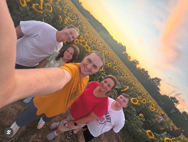 Group selfie in a sunflower field