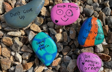 Rocks of kindness gathered in a garden. KINDNESS ROCKS_RocksGarden