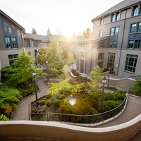 the sun shines through the arch at the Haas School of Business