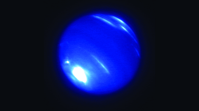 blue Neptune with white clouds scattered over surface and at south pole