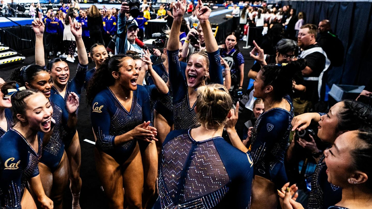 The Cal women's gymnastics cheers together with exuberance