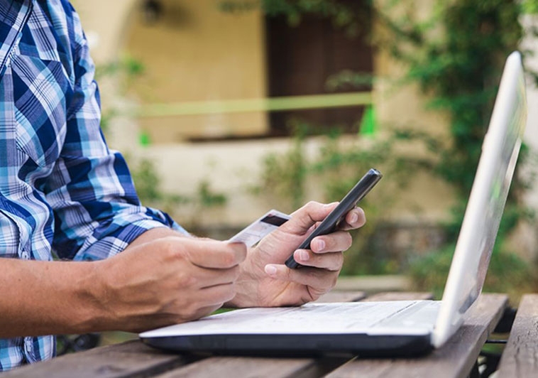 person-holding-phone-and-card-tile