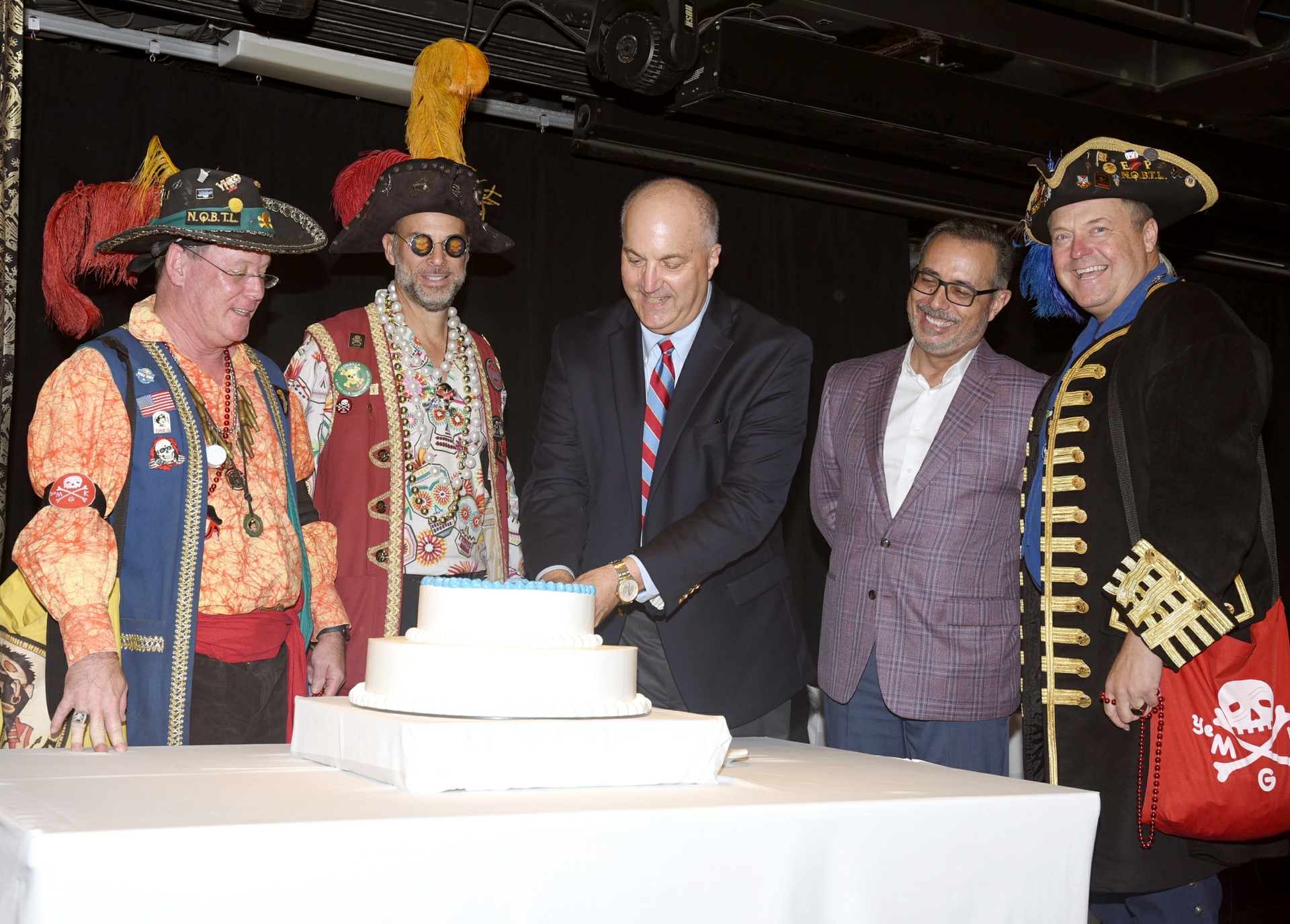 Carnival Chief Communications Officer Chris Chiames and Port Tampa Bay Executive Vice President Raul Alfonso join local Gasparilla pirates to cut 30th anniversary cake (Image at LateCruiseNews.com - September 2024