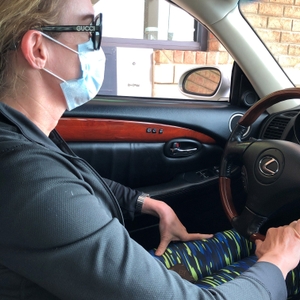 Woman wearing a mask at a drive-thru window