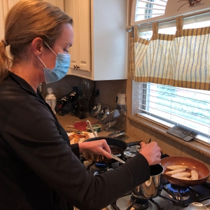 Woman wearing a mask while cooking