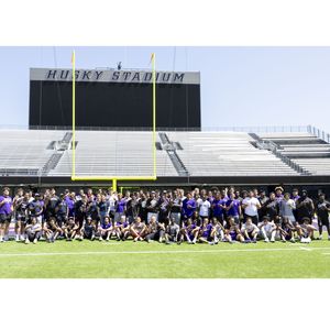 Members of the University of Washington football team pose for a group photo