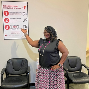 Brae Dewalt with the YMCA Blood Pressure Monitoring Sign at the Summerville YMCA