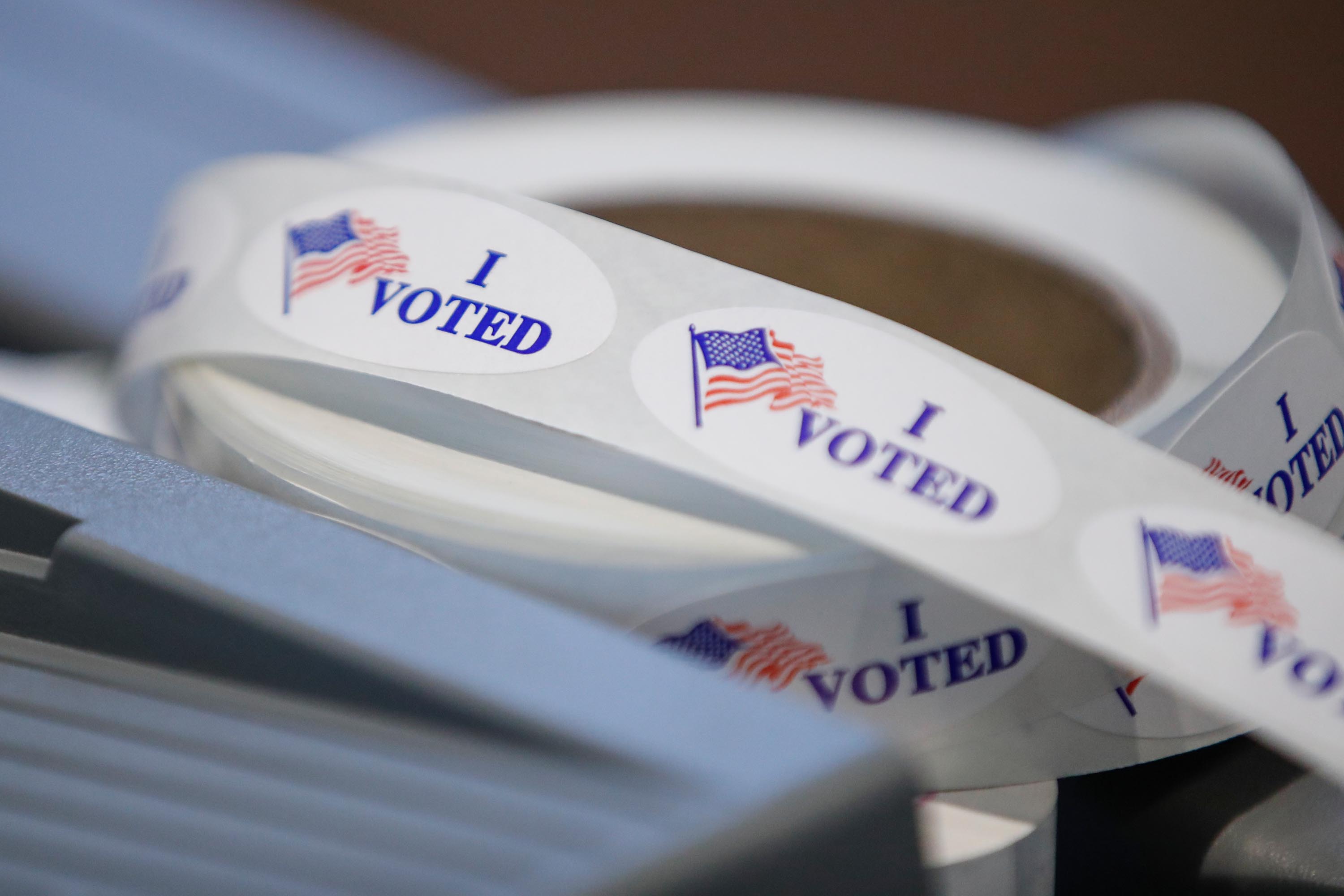 Key swing state Wisconsin opens in-person voting as Covid cases hit record-breaking spike
