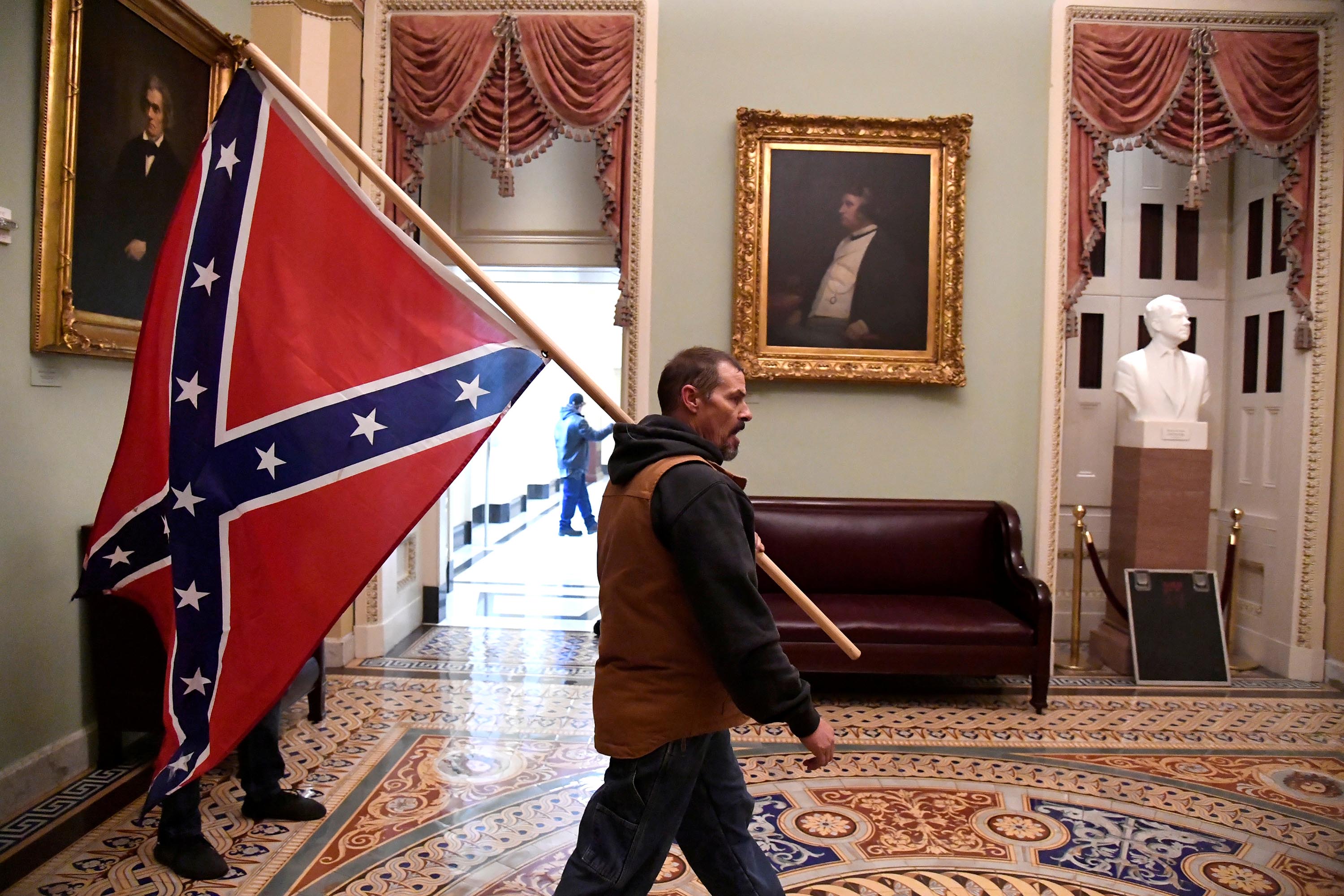 Man carrying Confederate flag inside the US Capitol during riot arrested, identified as Kevin Seefried