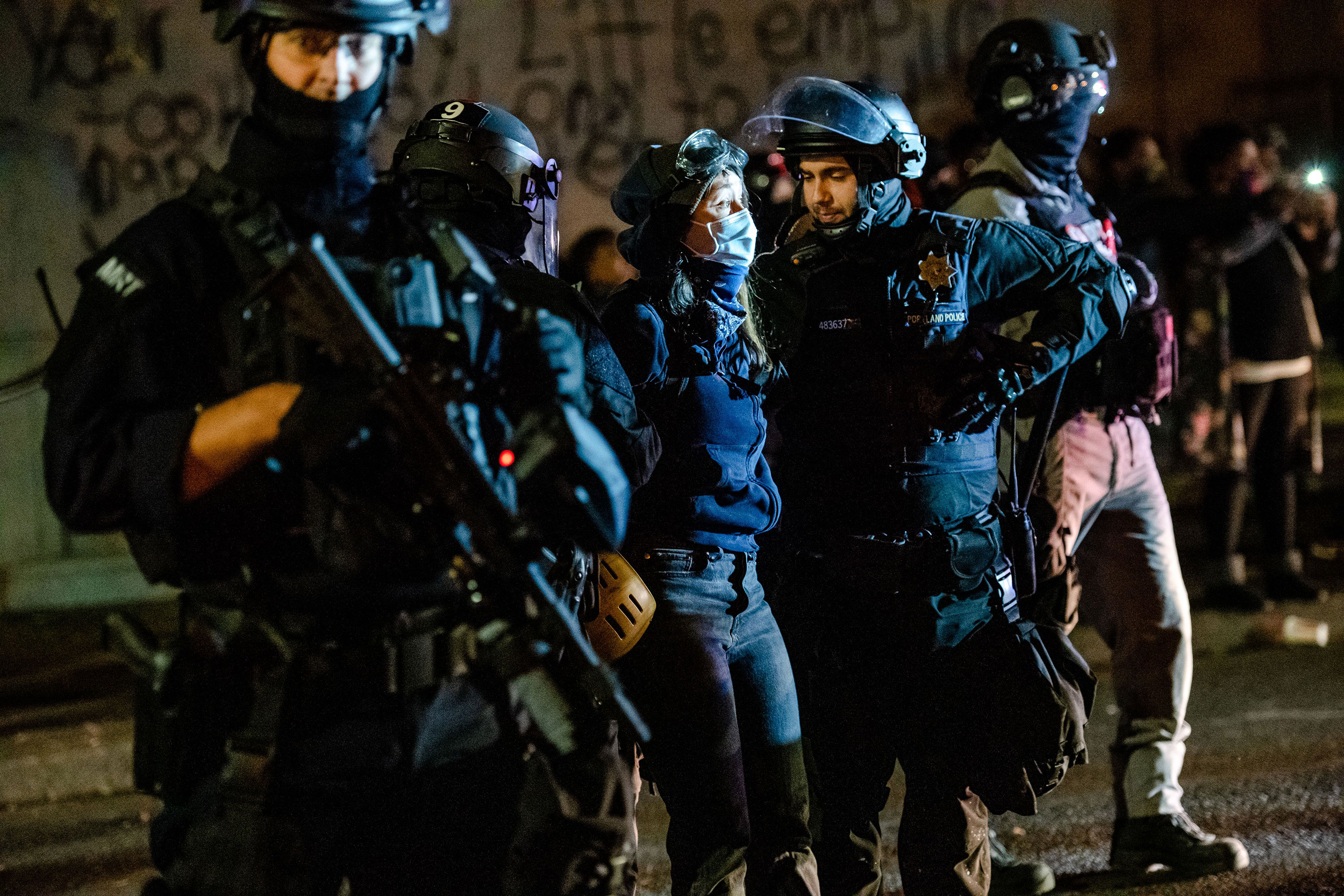 Portland protests remain largely peaceful until night falls and police are targeted, authorities say