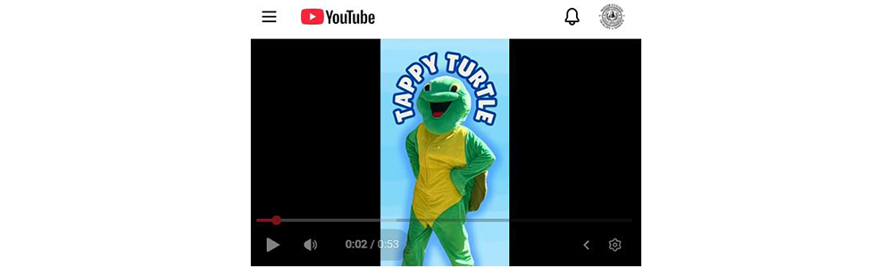 a green turtle mascot on a video screen