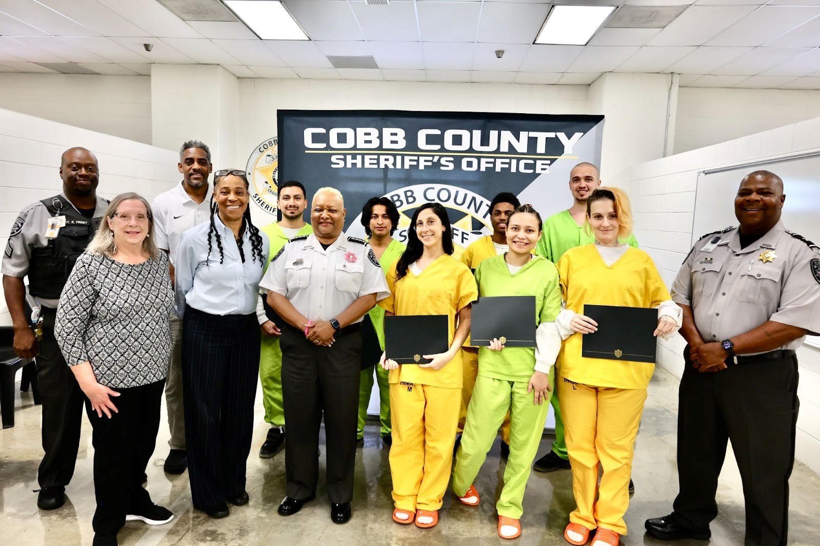 Seven graduates from Sheriff's GED program with staff