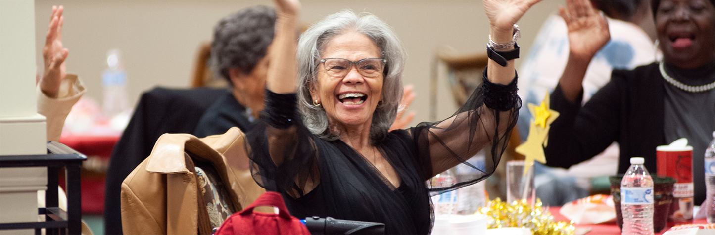 senior smiling and clapping