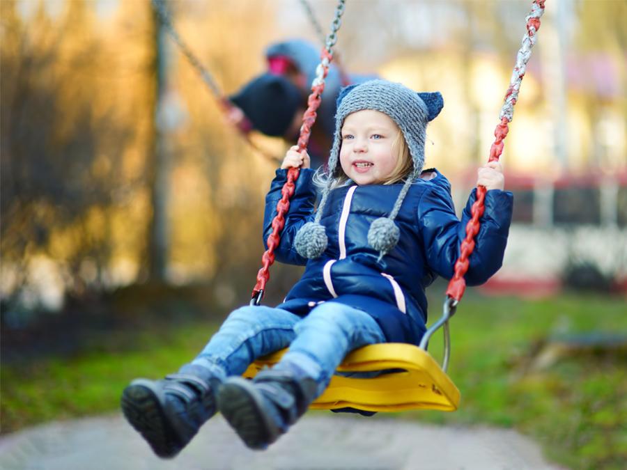 girl swinging on a cold day