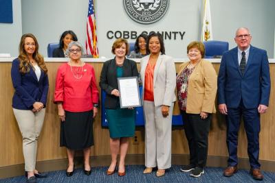 Group poses with proclamation for operation green light