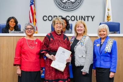 Group poses with proclamation for Native American Heritage month