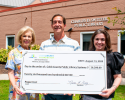 Members of the Cobb Library Foundation stand with the Cobb Library Director with an oversized check