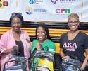 Judge's Stuff the Bus program photo posing with backpacks in front of a bus
