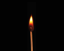 a black background with a single lit match in the middle