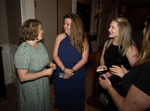 Author Jennifer Nielsen, left, greets Cobb Library Foundation members at its annual Booked for the Evening Gala, held Friday at the Atlanta Country Club.