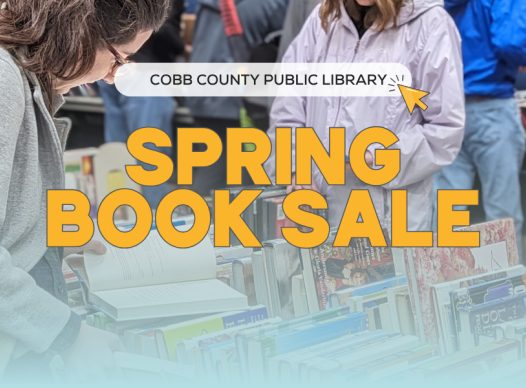 a photograph of a woman looking at an open book on a table covered with dozens of other books