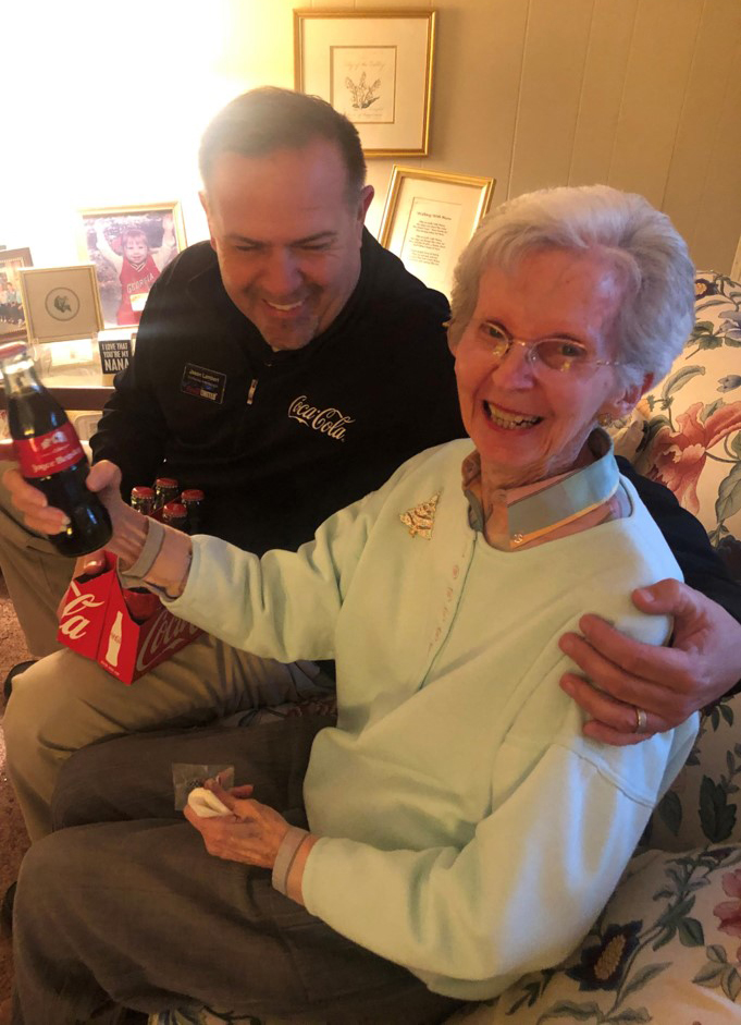 Jason Lambert with Joyce Beasley holding her personalized glass bottle