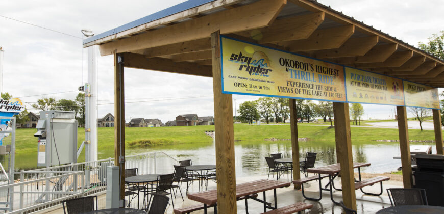 Zipline area with picnic tables and waterfront
