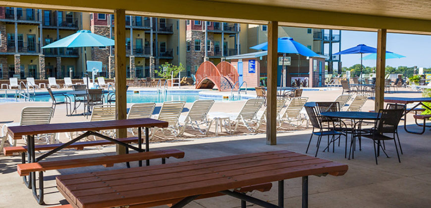 Picnic table setup by the outdoor pool