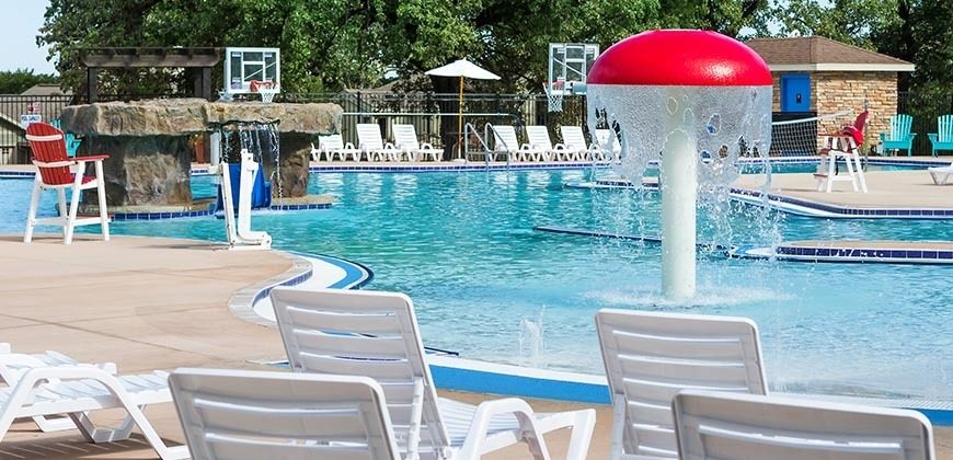 outdoor pool with beach chairs and a mushroom with dropping water