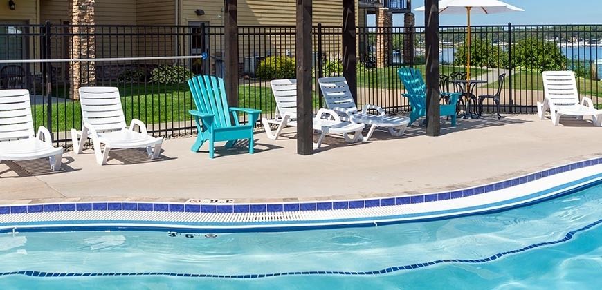 Chairs lined up on the outside of the pool for relaxing