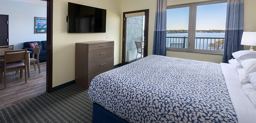 King Bedroom with dresser and TV and door to patio