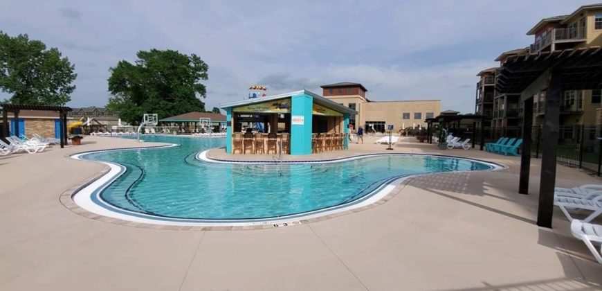 Far away shot of the pool with a swim up bar