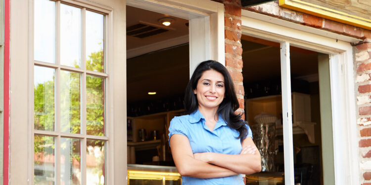 Woman standing outside her bakery
