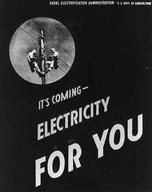 Image features an early advertisement, circa 1935, promoting the coming of the local rural electric cooperative. The ad reads "It's coming! Electricity for you!"