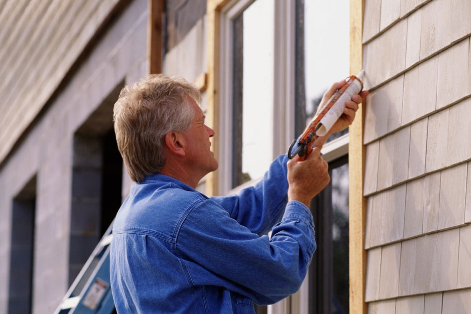 image features an image of a homeowner caulking his windows