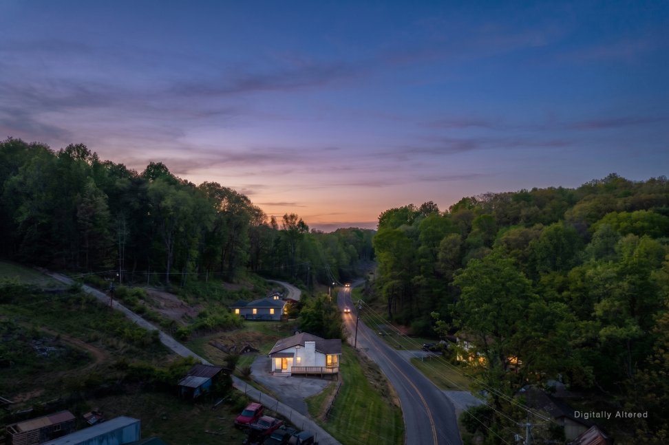 The home at dusk, aerial view