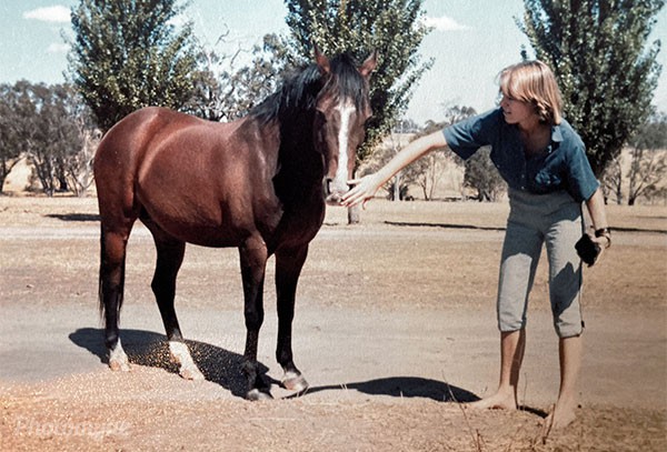 Bobby and Tory, in the House Paddock - Summer 1980. The natural light, the quiet setting, and that shared glance capture a timeless bond between human and horse, a simple moment of trust, understanding, and calm.