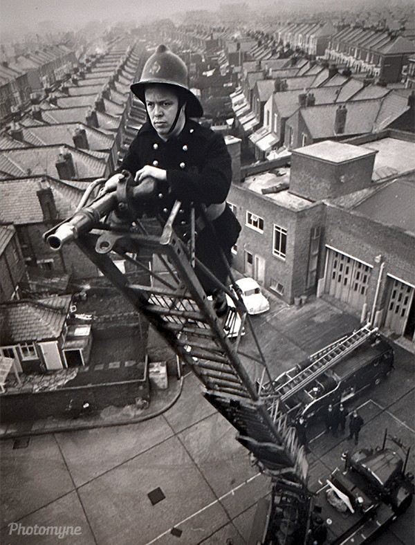 Maurice on a ladder. The quiet resolve of everyday work, carried out high above the city in another time. Britain, circa 1930s.