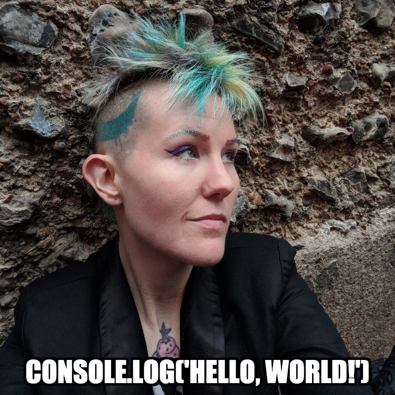 developer evangelist Tilde Ann Thurium looking away from the camera with the text "console.log('hello world')" imposed over the image.
