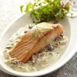 Salmón con salsa de champiñones acompañado de mix de hojas verdes