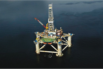 Offshore drilling platform 'Atlantic Star' in operation at sea, with visible helideck and robust structure for drilling.
