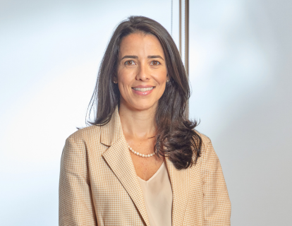 Profile photo of Silvia Ruggeri, a white woman smiling, with shoulder-length dark hair. She wears a beige blazer over a white top and a pearl necklace.