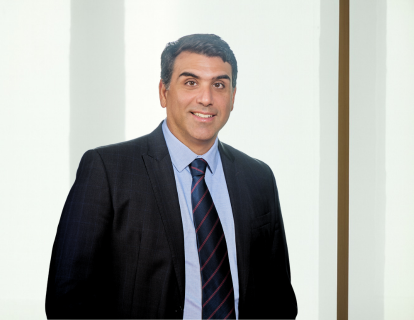 Profile photo of Luis Guilherme Senna, a white man with short dark hair, smiling, wearing a dark blue suit, white shirt and striped tie.