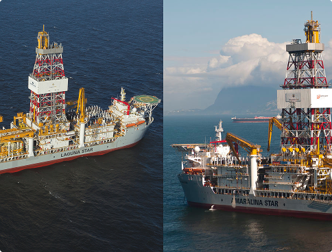 Image divided vertically showing two drillships in operation. To the left, the 'Laguna Star' viewed from above at an angle. To the right, the 'Amaralina Star' viewed laterally with mountains and clouds in the background. Both display large latticed derricks and gray and red hulls.